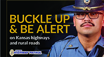 Kansas Highway Patrol trooper in uniform with the words "Buckle Up & Be Alert"